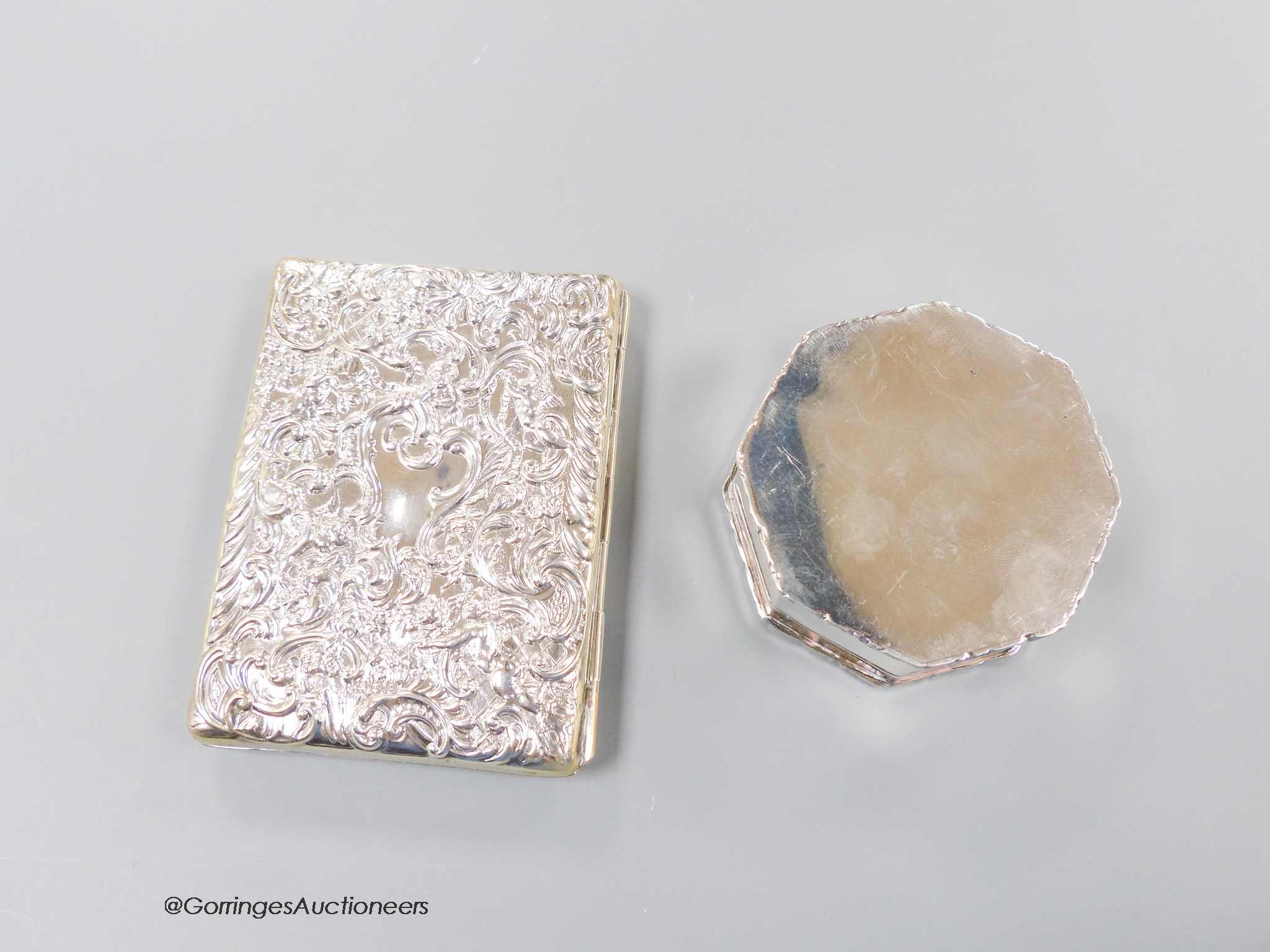 A late Victorian repousse silver mounted card purse, William Comyns, London, 1900, 10cm and a later silver octagonal trinket box.